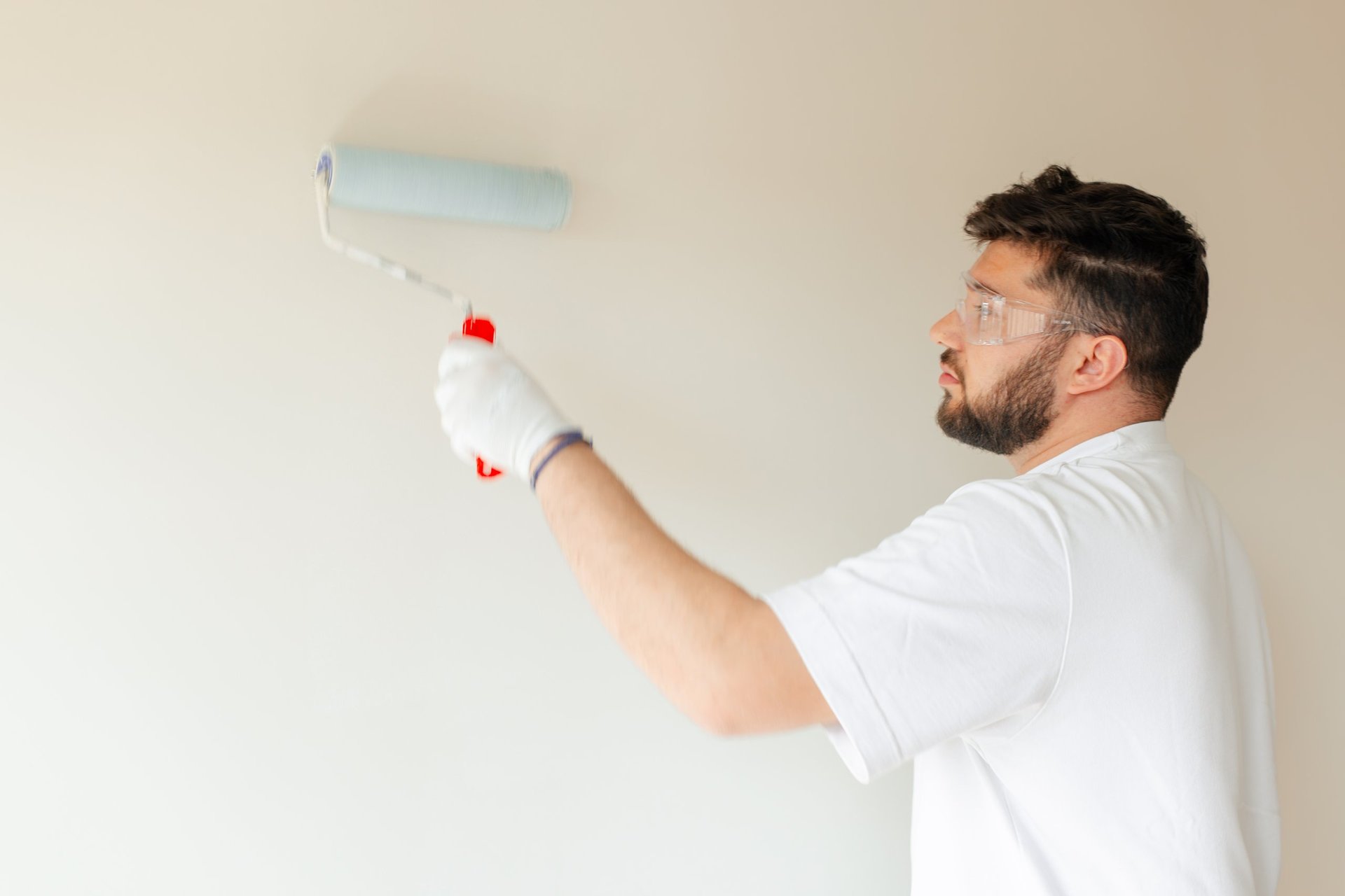 Professional painter working on interior wall