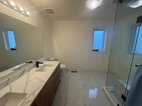 Modern bathroom with marble countertops and dual sinks
